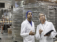 Quality control workers inspecting at bottling plant